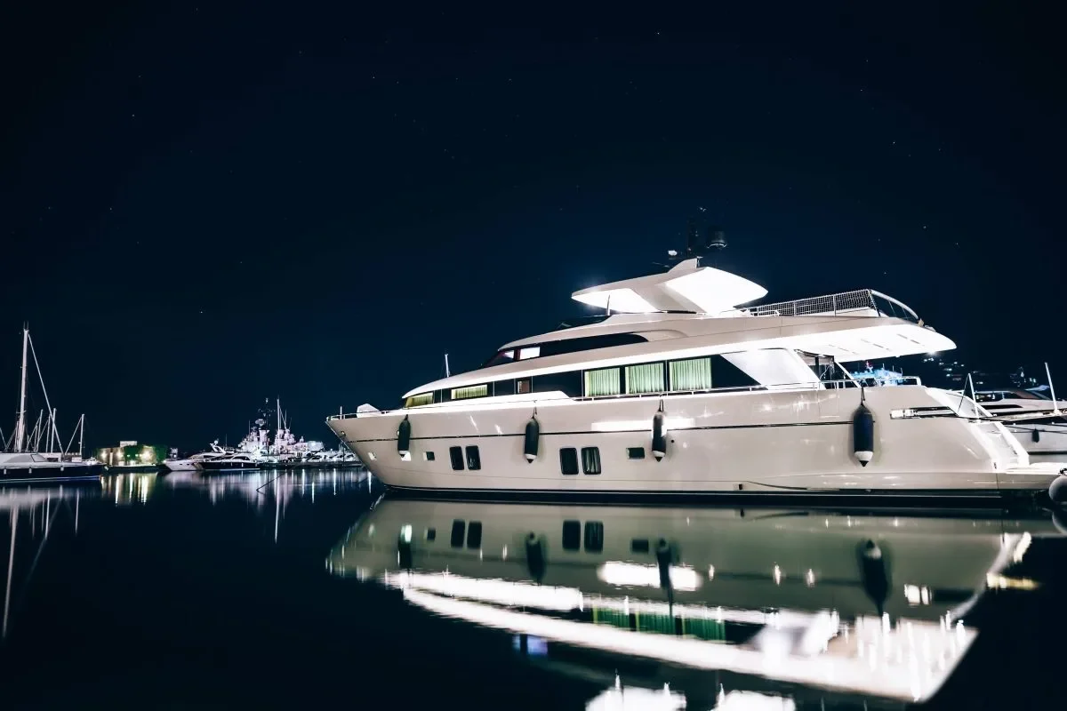Superyacht illuminated at night moored in a marina